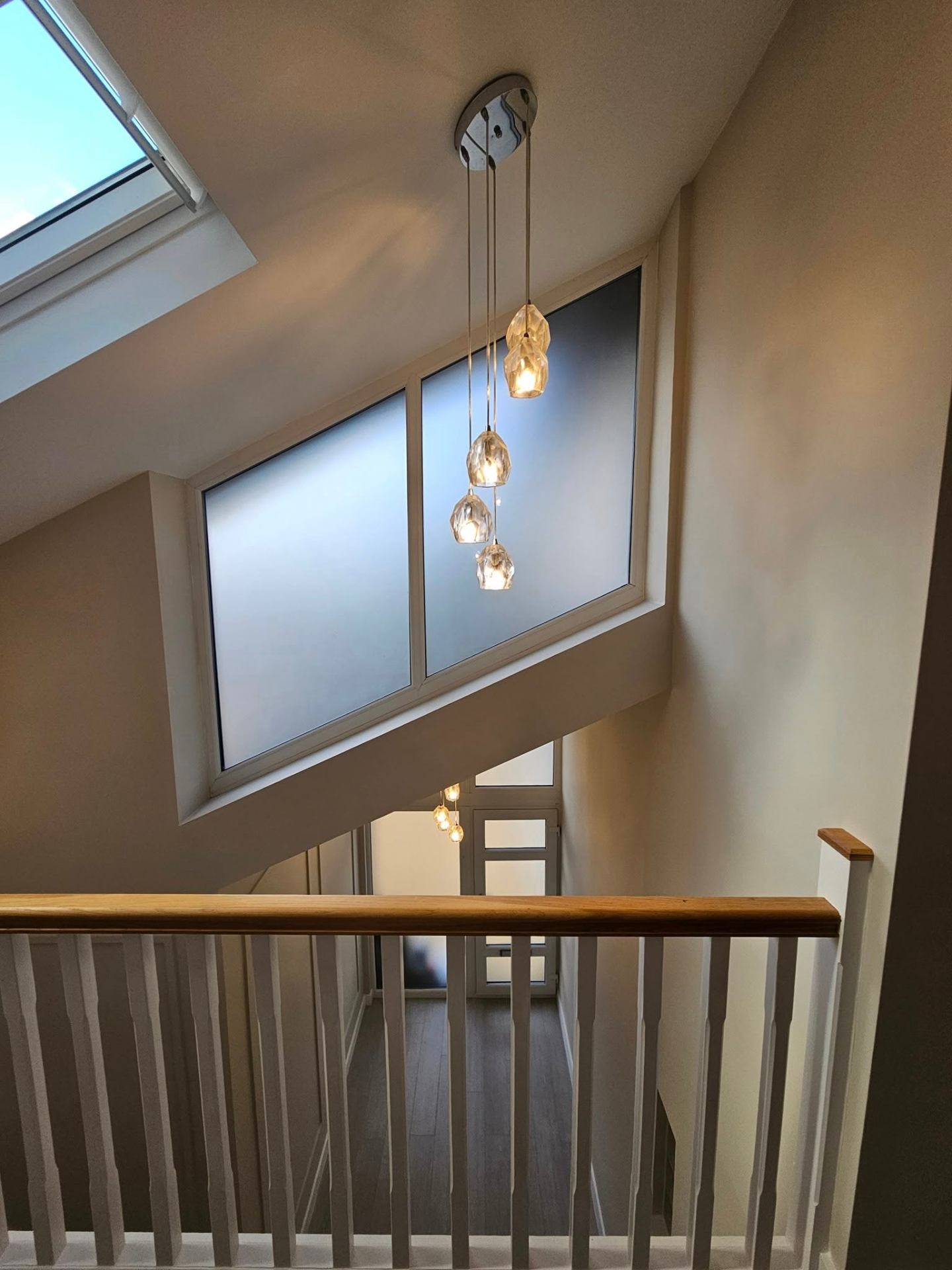 Modern landing with painted spindles and warm neutral walls — Newport interior painting