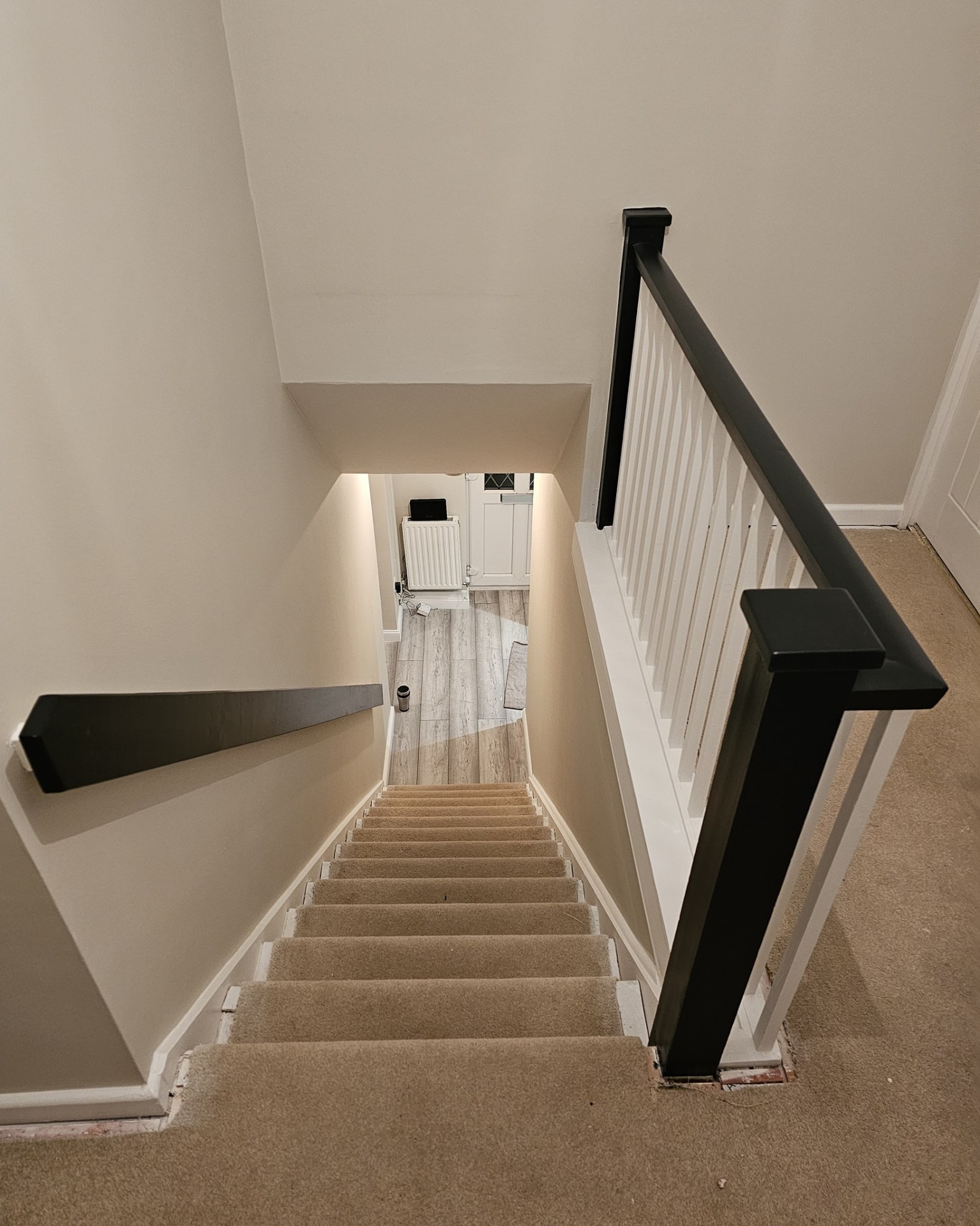Freshly painted cream kitchen island with oak worktop