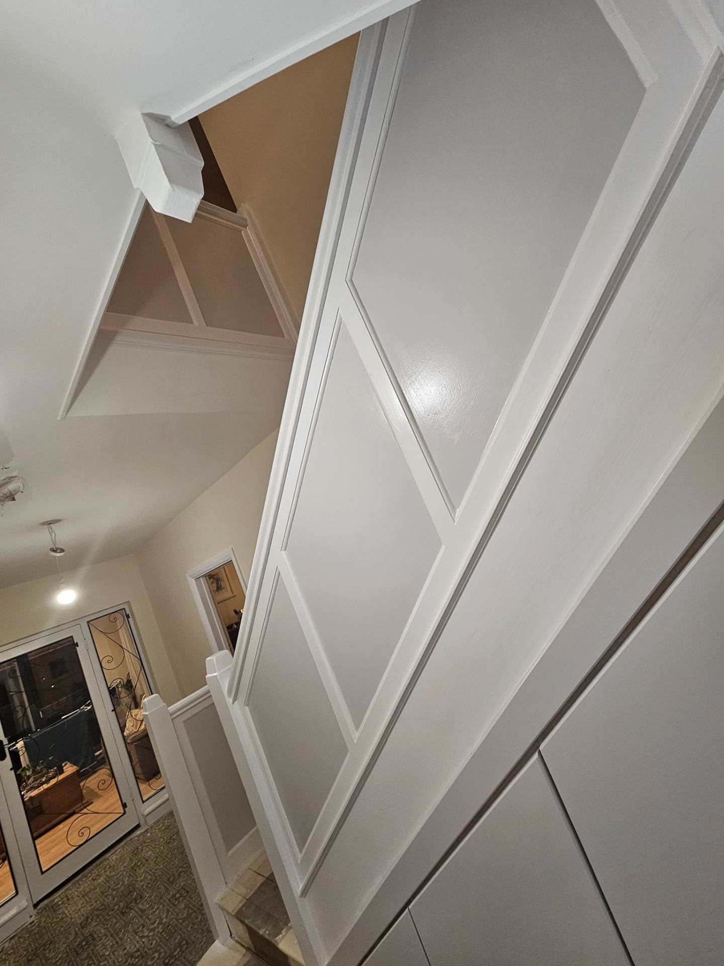 Painted spindles, handrail and skirting in a bright stairwell