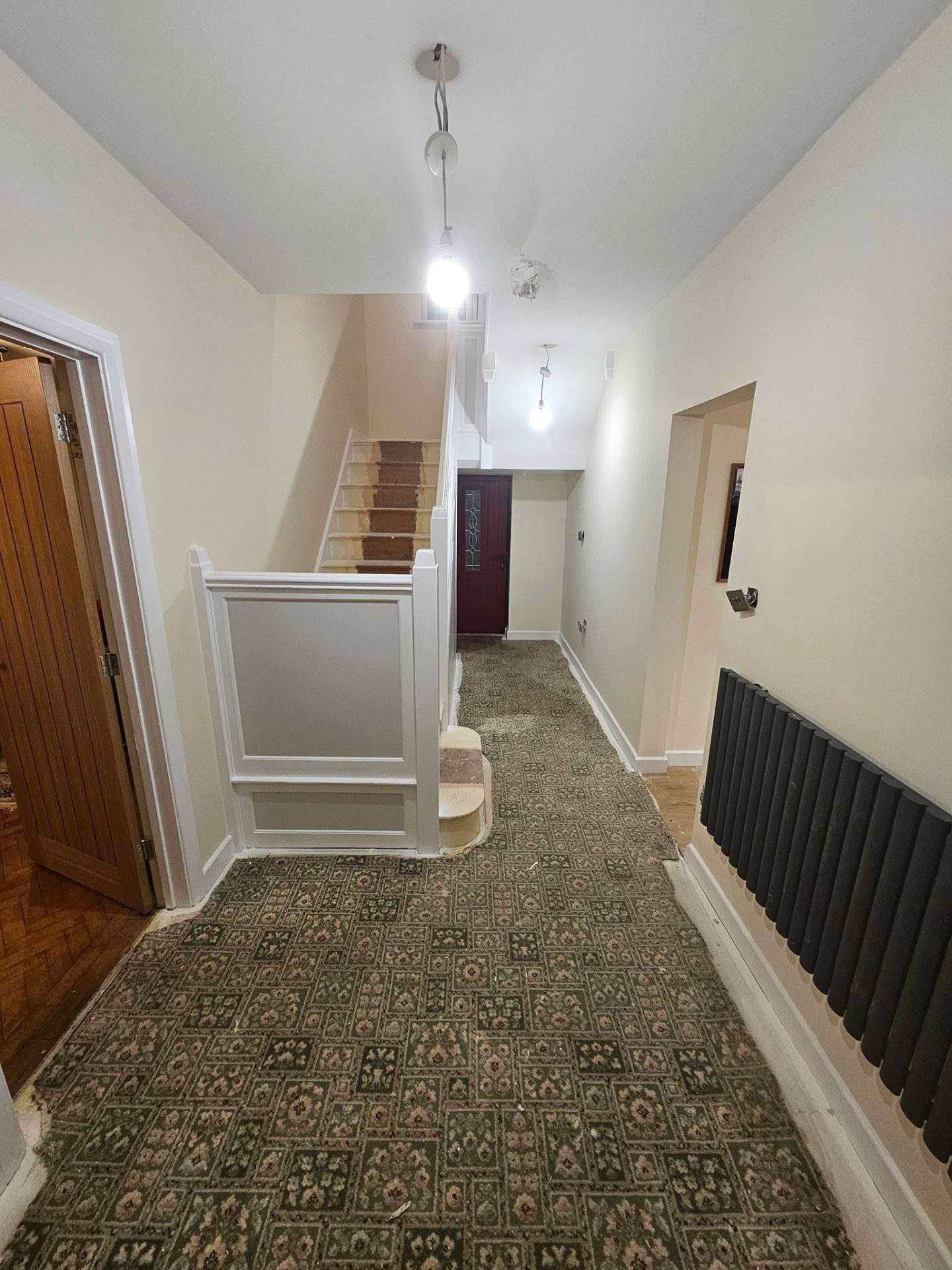 Refurbished hallway with new flooring and freshly painted walls and ceiling