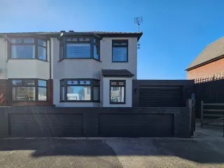 Modern home with grey render and dark UPVC after exterior refresh — serving Caerphilly