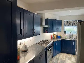 Sprayed navy kitchen cabinets — kitchen respray in South Wales — serving Caerphilly