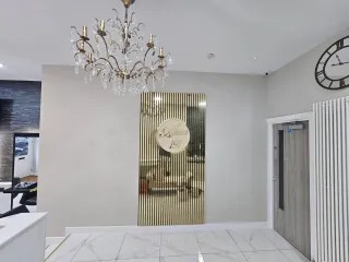 Salon entrance with painted feature panel and crisp marble palette