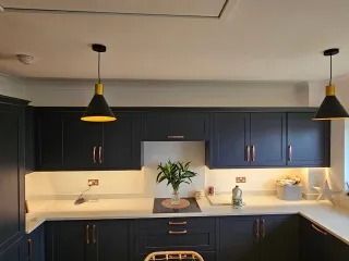 Newly painted navy shaker kitchen cabinets with brass handles — Newport kitchen respray