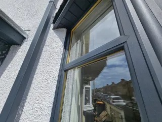 Sprayed anthracite-grey UPVC window restoration on Newport home